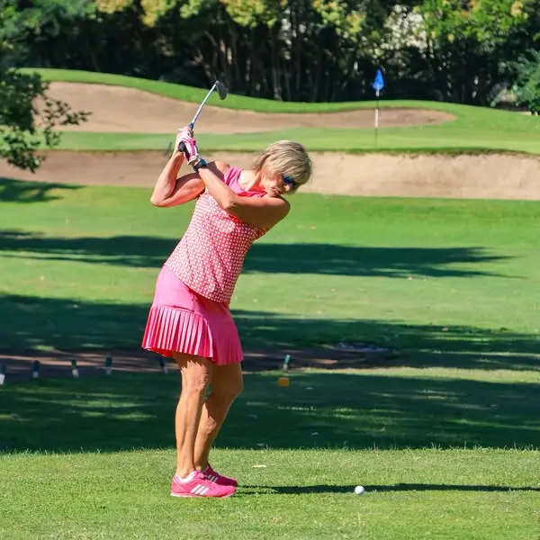 Female golfer swinging at William Land Golf Course in Sacramento