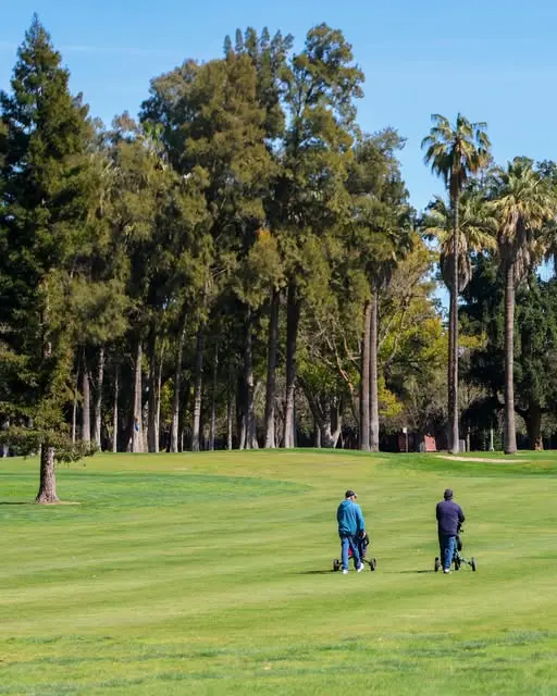 Golfers walking fairway with push carts at William Land Golf Course Sacramento