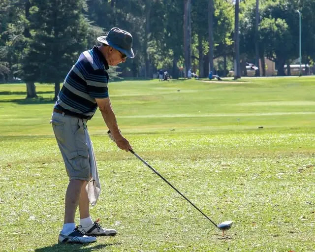 Male golfer teeing off at William Land Golf Course in Sacramento
