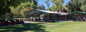 Mulligan’s Cafe at William Land Golf Course with outdoor seating and golf carts