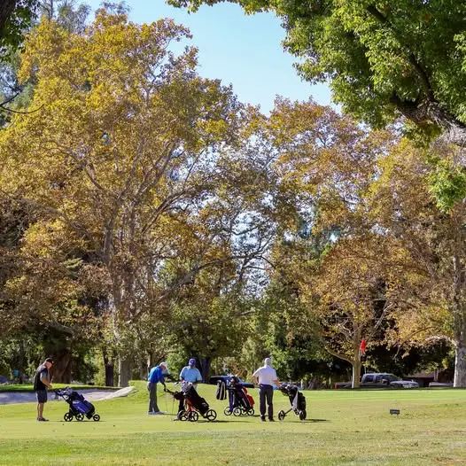 Golfers on fairway with push carts at William Land Golf Course Sacramento