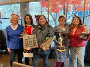 Women golfers with trophies at William Land Golf Course Sacramento clubhouse