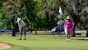 Golfers putting on green at William Land Golf Course in Sacramento