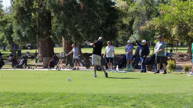 Golfer teeing off during group play at William Land Golf Course in Sacramento